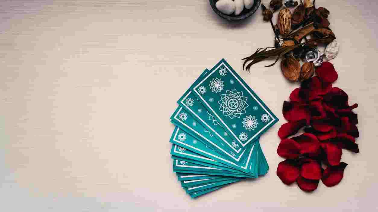 Des cartes de tarot bleues sur une table blanche